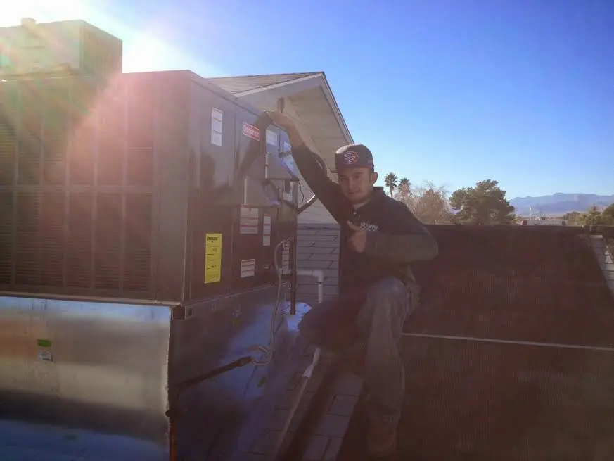 HVAC technician performing AC Tune-Up on a rooftop unit in Tarpon Springs